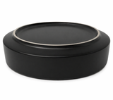 Matte black round decorative tray with subtle metal rim detail on a clean background, modern minimalist home decor accessory