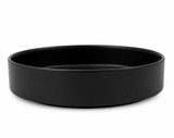 Matte black round decorative tray isolated on a clean background, modern minimalist home decor accessory