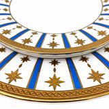 Close-up detail of porcelain plate rim featuring blue stripes and gold star pattern with intricate gold border design, elegant decorative tableware craftsmanship