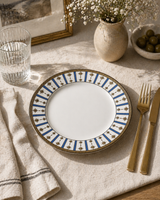 Blue and gold star porcelain plate styled on a minimal stone table with neutral decor, linen napkin, and gold fork for a modern elegant dining aesthetic