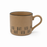 Beige mug with black interior and decorative pattern on a white background