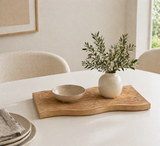 Organic wooden textured decorative tray styled with ceramic bowl and vase on a modern dining table with natural light and minimalist home decor
