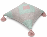 Side view of pastel geometric throw pillow with blush pink tassels featuring soft mint and neutral textured pattern on woven fabric