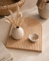Wooden textured decorative tray styled with ceramic vase, dried pampas grass, and small bowl on a neutral surface, modern boho home decor setup